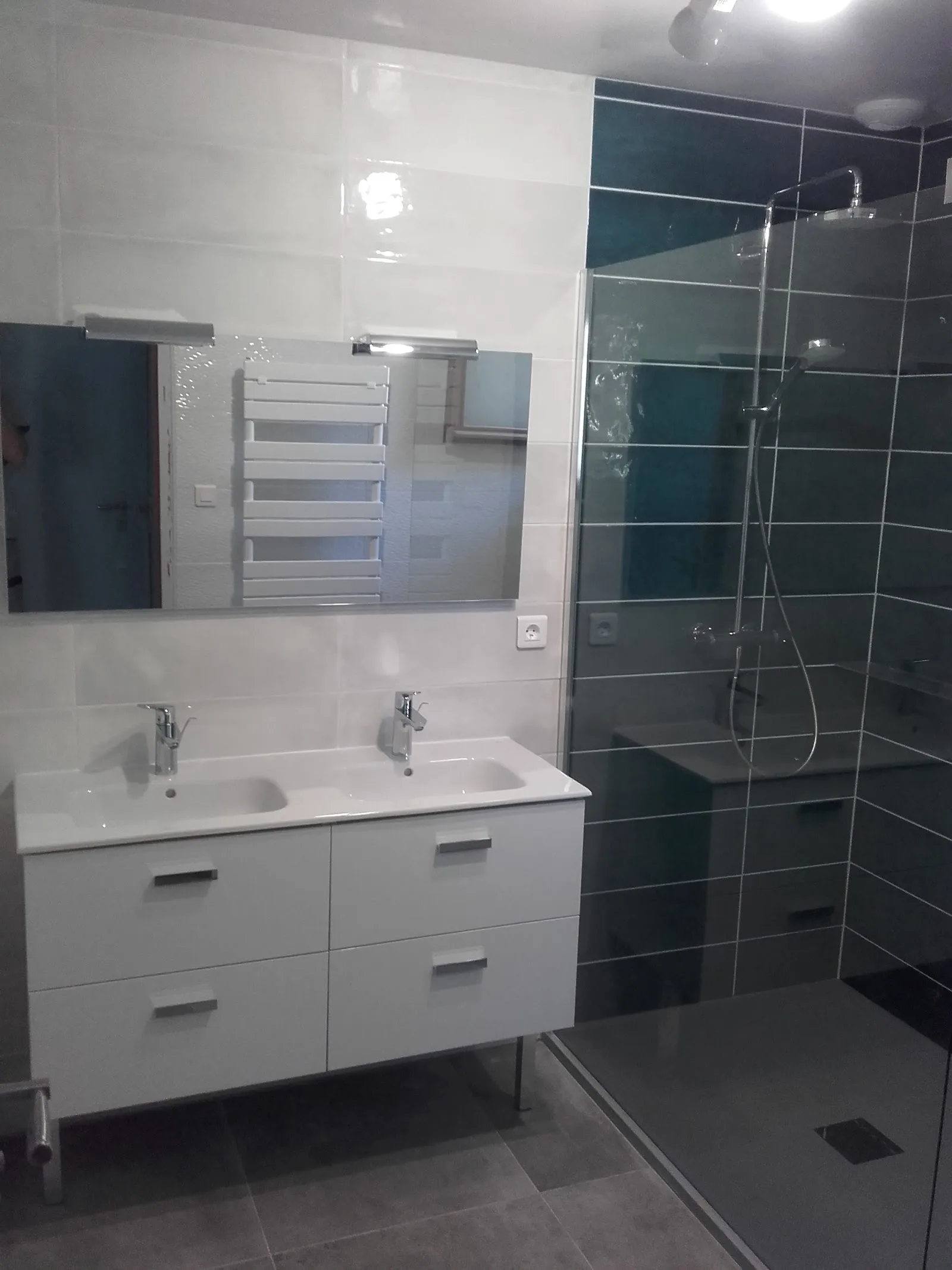 Salle de bain rénovée avec meuble double vasque et douche vitrée